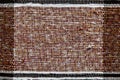 Colorful woven rug made of cotton thread. Handmade fabric fragment of brown color