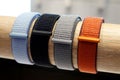 colorful wrist watch straps. Leather silicone strap for electronic watches, on a wooden stand.