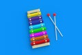 Colorful xylophone and sticks on blue background. Kids toy. Preschool education. Musical instrument Royalty Free Stock Photo