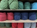 Yarn balls for knitting being arranged on a shelf in a store. Royalty Free Stock Photo