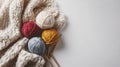 Colorful yarn balls with knitting needles and a knitted blanket on white background Royalty Free Stock Photo