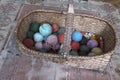 Colorful yarn skeins in the old wicker arm basket Royalty Free Stock Photo