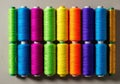 Colorful yarn spools arranged in grid on flat surface Royalty Free Stock Photo
