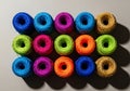 Colorful yarn spools arranged in grid pattern on flat surface Royalty Free Stock Photo