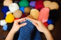 Colorful yarn stacked in a series of colors. Balls and skeins of colored yarn for knitting. A woman going to knit.