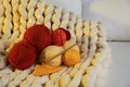 Colorful yarns, crochet pattern, hook and festive lights on blanket Royalty Free Stock Photo