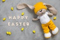 Colorful yellow Easter eggs, bunny toy and text happy easter Royalty Free Stock Photo