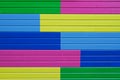 Colorful yellow, green, blue and pink painted wooden wall Royalty Free Stock Photo