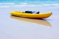 Colorful yellow kayaks on beach