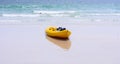 Colorful yellow kayaks on beach