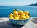 colorful yellow lemons arranged in a blue bowl