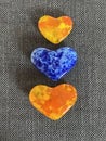 Colorful yellow orange and blue glass heart paperweights