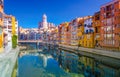 Colorful yellow and orange houses and bridge Pont de Sant Agusti reflected in water river Onyar, in Girona, Catalonia, Spain Royalty Free Stock Photo