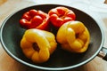 Colorful yellow sweet peppers in a frying pan