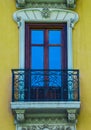 Colorful yellow traditional window and balcony in Spain with stucco decoration Royalty Free Stock Photo