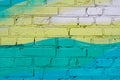 Colorful yellow and turquoise painted brick wall