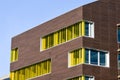 Colorful yellow windows in a modern architecture building. Royalty Free Stock Photo