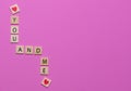 Colorful You and Me game tiles with hearts on a pink background to celebrate love