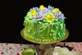 Colorful yummy springtime cake decorated with yellow and purple icing flowers