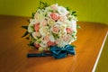 Colorfull bouquet of flowers ant tiebow on the brown table Royalty Free Stock Photo