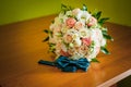 Colorfull bouquet of flowers ant tiebow on the brown table Royalty Free Stock Photo