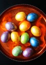 Colorfull eggs painted for Easter lie on a fire tray