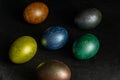 Colorfull marble painted easter eggs on black background. Concept of minimal festive Easter backdrop