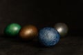 Colorfull marble painted easter eggs on black background. Concept of minimal festive Easter backdrop