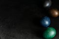 Colorfull marble painted easter eggs on black background. Concept of minimal festive Easter backdrop