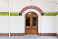 Colorfull mosaic wall with wooden door