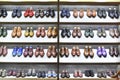 Colorfull pairs of shoes are exposed for sale.