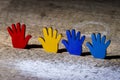 Colorfull puzzles hands on wooden table. World Autism Awareness Day Concept