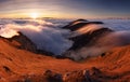 Colorfull sunset behind Mountain peak landscape above clouds - panorama Royalty Free Stock Photo