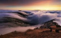 Colorfull sunset behind Mountain peak landscape above clouds - panorama Royalty Free Stock Photo