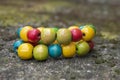 Colorfull wood beads on thread, fashionable beaded bracelets, bright beautiful colors green red yellow and light blue