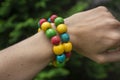Colorfull wood beads on thread, fashionable beaded bracelets, bright beautiful colors green red yellow and light blue
