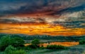 Colorfully clouds at sunset. lake reflecting sky and forest Royalty Free Stock Photo