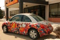 A colorfully decorated VW Beetle