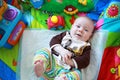 Colorfully dressed little boy playing on the floor