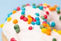 Colorfully sprinkles on white donut glaze