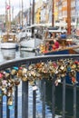 Colorfur love padlocks on the bridge over the canal in Nyhavn, Copenhagen, Denmark