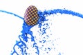 Coloring Easter Egg, Vibrant blue Paint pouring over painted egg isolated on white Background. 3d illustration Royalty Free Stock Photo