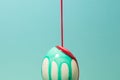 Coloring Easter Egg, Vibrant Red and Green Paint pouring over an Royalty Free Stock Photo