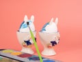 Coloring Easter eggs. Decorate eggs for Easter on a pink background. Royalty Free Stock Photo