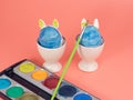 Coloring Easter eggs. Decorate eggs for Easter on a pink background. Royalty Free Stock Photo