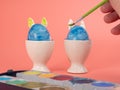 Coloring Easter eggs. Decorate eggs for Easter on a pink background. Royalty Free Stock Photo