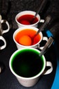 Coloring hard boiled Easter eggs in coffee cups Royalty Free Stock Photo