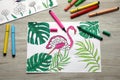 Coloring pages with children drawings and set of felt tip pens on wooden table, flat lay Royalty Free Stock Photo