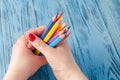 Coloring pencils bunch in a hand shot top view Royalty Free Stock Photo