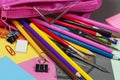 Coloring pencils spilling from a pink pencil case Royalty Free Stock Photo